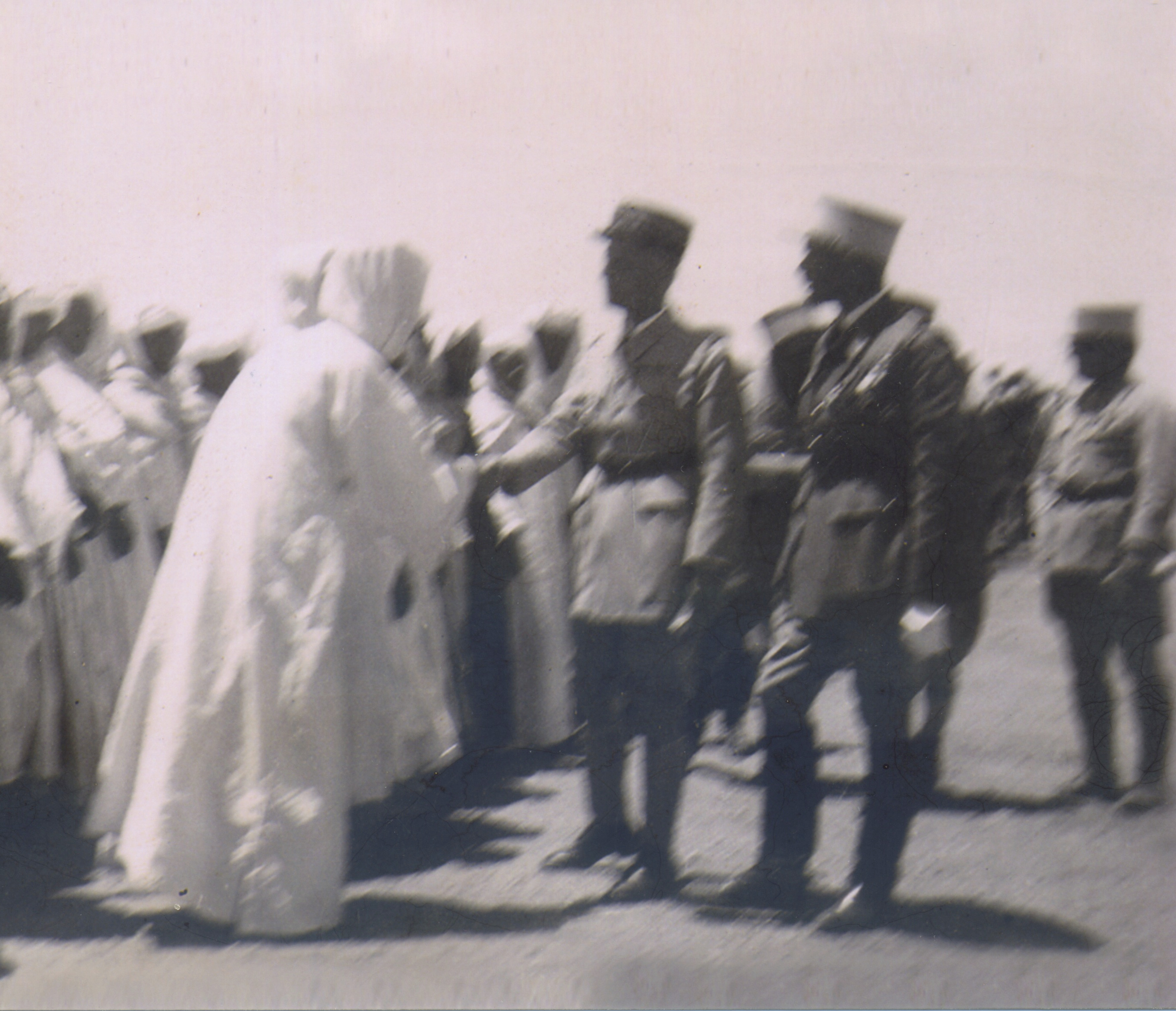 French military personel shaking hands with Moroccan civilians