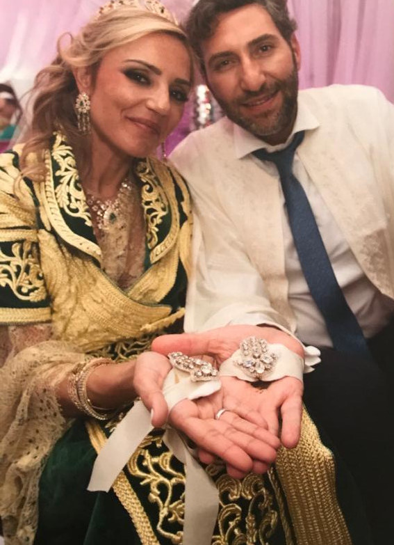 A woman and man holding jewellery